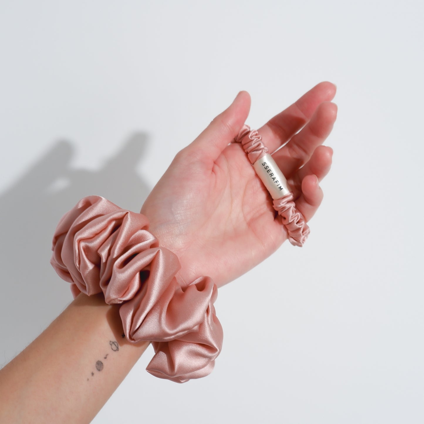 skinny mulberry silk scrunchies  pink color - front hand  by sserafim